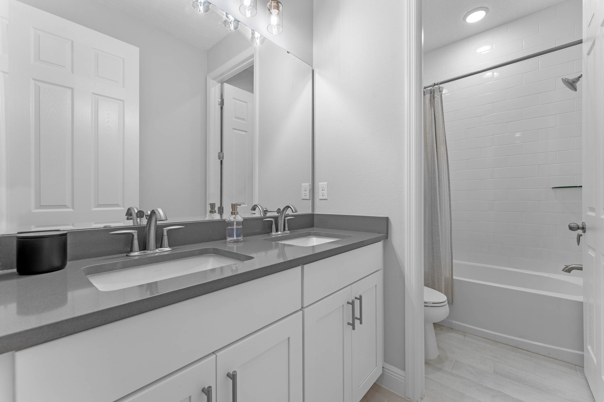 guest bathroom with dual sinks and grey counter